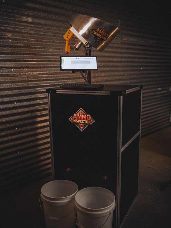 AccuWeigh 360 weight inspection system with collator feed on a black cabinet